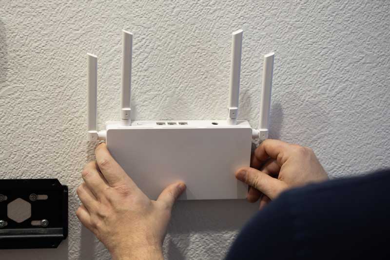 For optimal connectivity, installing a wireless router on the wall can enhance signal strength